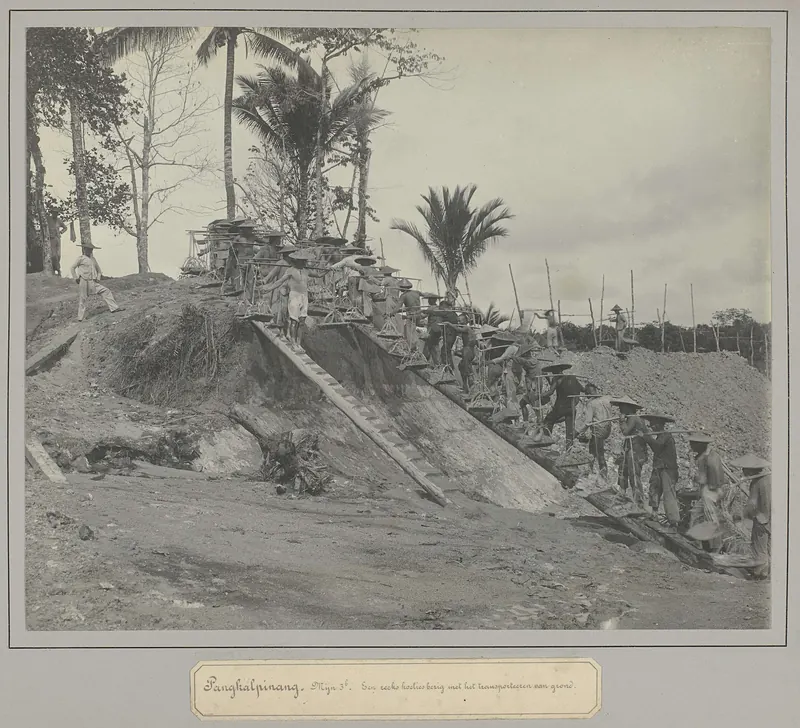 Workers moving earth at a tin mine at Pangkalpinang, Bangka