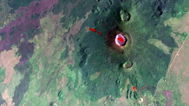 Satellite map view of the Nyiragongo volcano above the city of Goma and the blue water of Lake Kivu, with recent lava flows