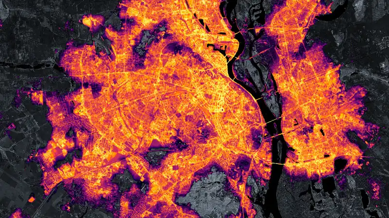 Satellite image of Kyiv at night in January 2022: the city a bright web of orange and white lights along the river