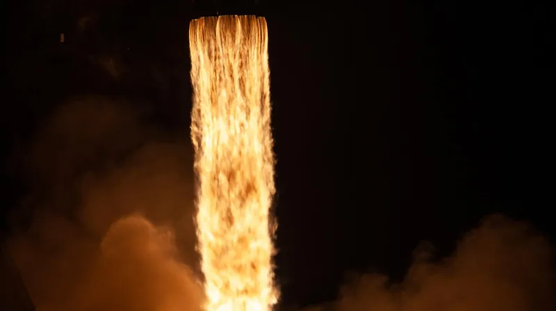 Close view of the bright plume of a Falcon 9's engines at night lift-off