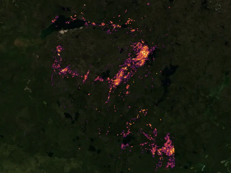 Uranium drill-hole columns over the Athabasca Basin on a satellite map of Saskatchewan