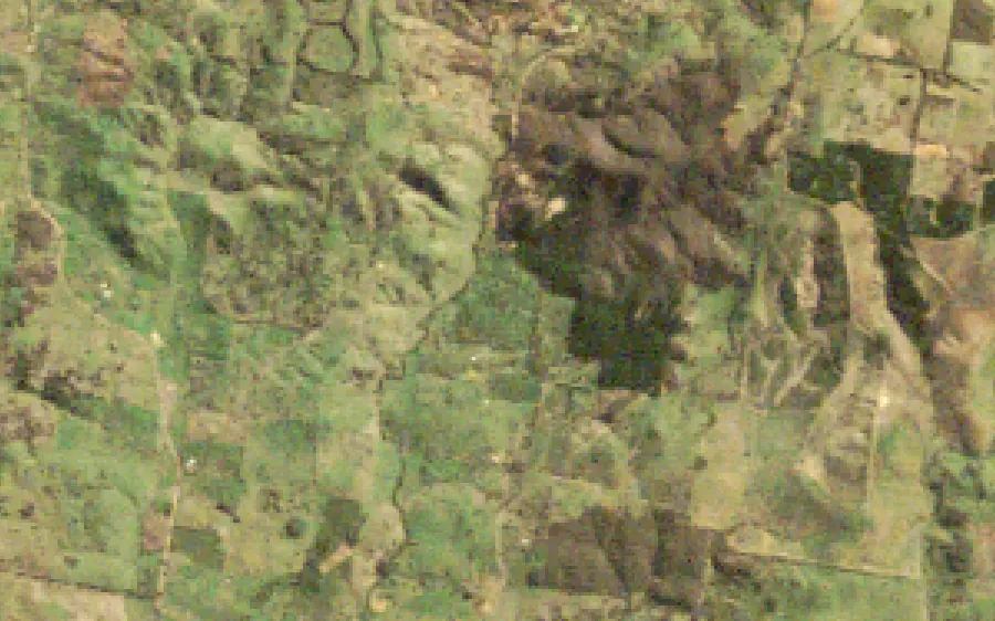 Farmland at Cadia in 1995, and in 2025 with the mine, its plant, waste dumps and tailings dams