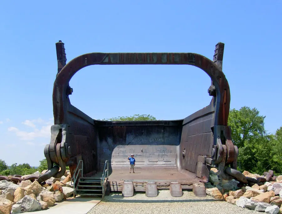Big Muskie's preserved steel bucket on display, with a person standing inside it for scale