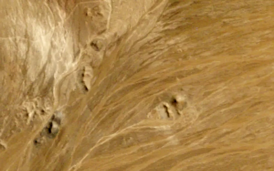 The Atacama desert at Gabriela Mistral in 1995, bare ground, and in 2025, with an open pit, waste dumps and leach pads