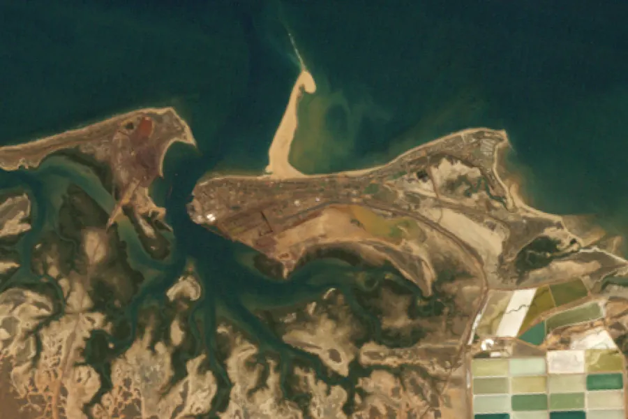 Port Hedland harbour and salt ponds in 1991, and in 2025 with more berths, stockyards and rail loops