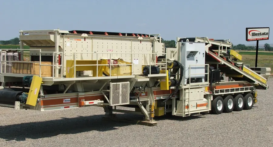 A portable crushing and screening plant mounted on a multi-axle trailer