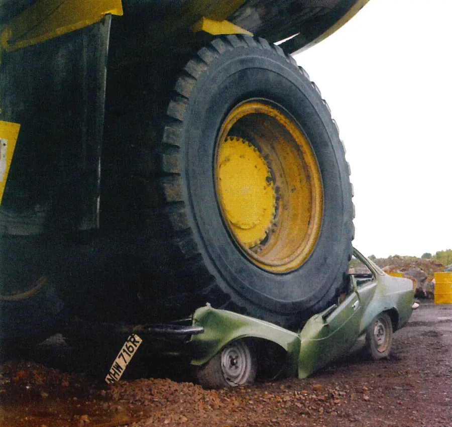 A pickup crushed under the rear tyres of a haul truck that reversed over it