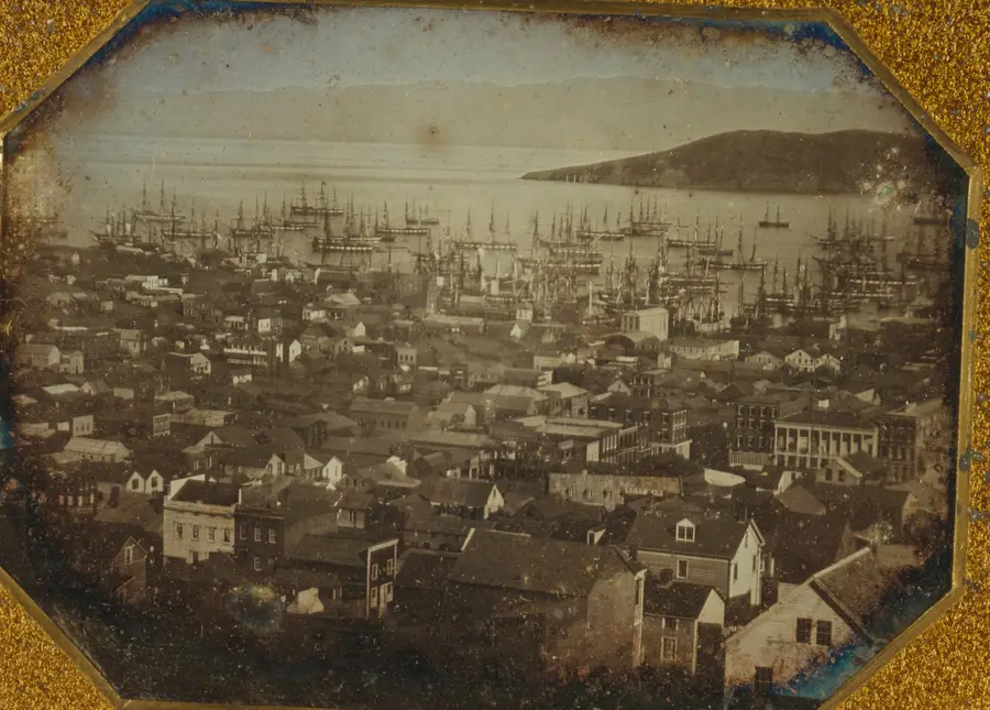 Daguerreotype of San Francisco in 1851: wooden buildings running down to a bay full of ships