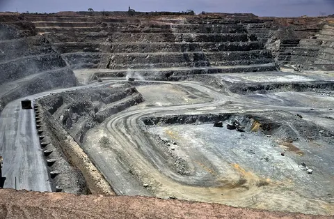 A wide stepped open pit with haul roads on its walls
